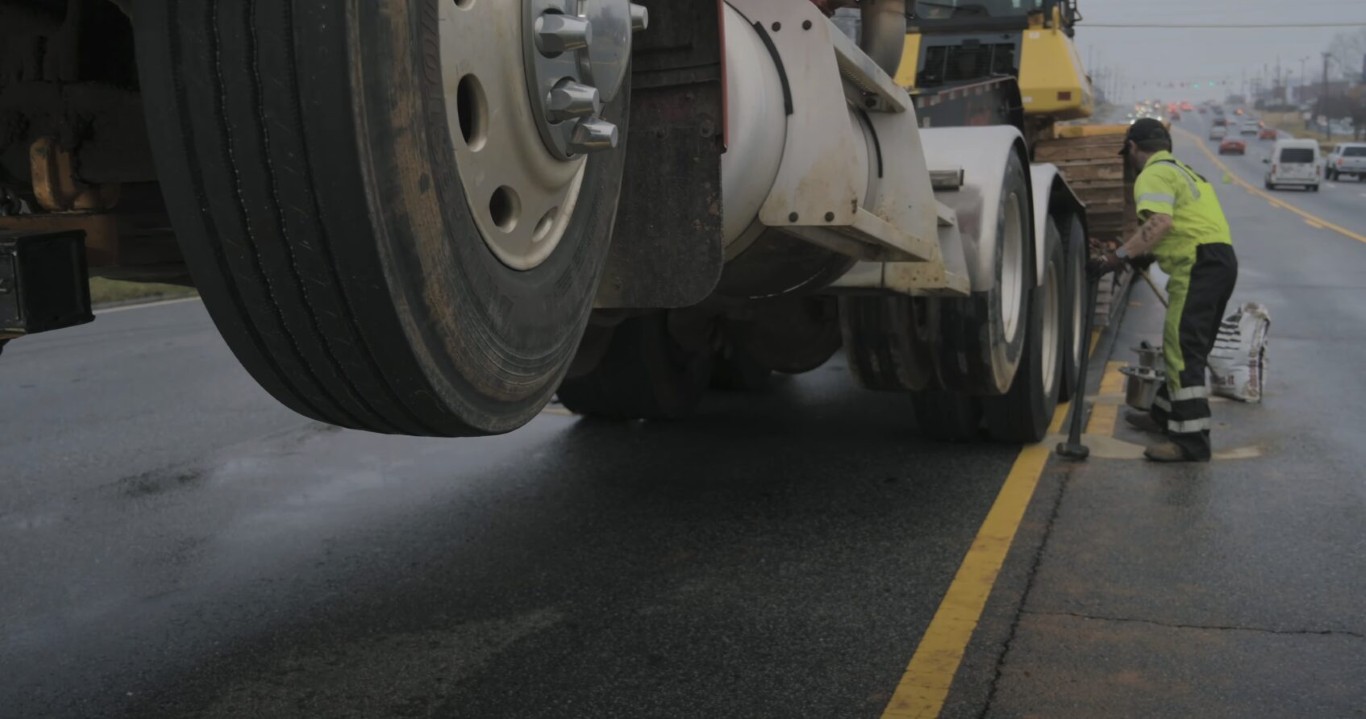 Roadside assistance technician providing tire change service in Poway